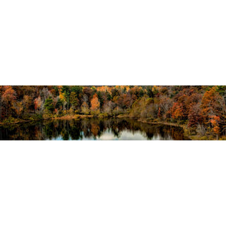A clear mountain lake reflects the autumn trees gathered around it, a tall, crowded forest full of muted browns, yellows, and oranges, and a few bright evergreens. Fall Lake Reflection by Alison Thomas of Serenity Scenes Photography and Digital Art.