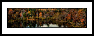A clear mountain lake reflects the autumn trees gathered around it, a tall, crowded forest full of muted browns, yellows, and oranges, and a few bright evergreens. Fall Lake Reflection by Alison Thomas of Serenity Scenes Photography and Digital Art.